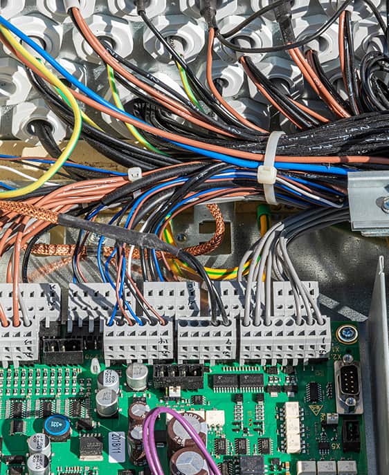 Detailed view of a computer motherboard with various wires connected to its components.