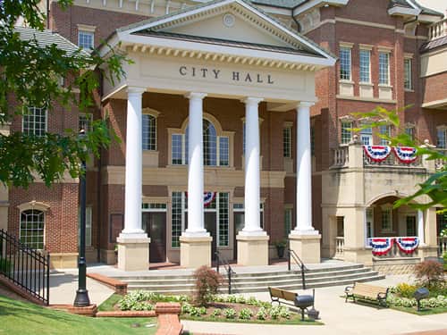 A grand building with tall columns and a clock, showcasing architectural elegance.