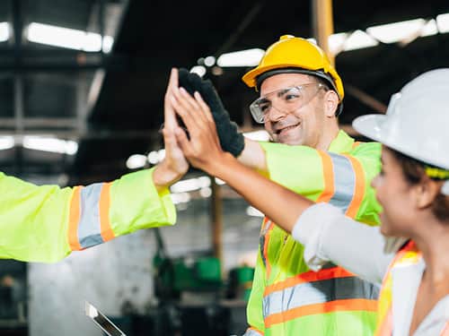A group of people wearing hard hats and safety glasses.
